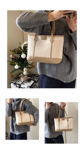 Detail of beige woven texture and brown leather trim on a large commute tote bag