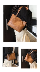 Detail of brown woven tote bag featuring a checkered texture and long shoulder straps