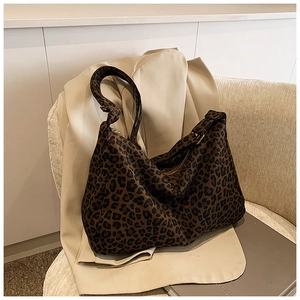Detail of vintage leopard print hobo bag with durable canvas texture and sturdy zipper