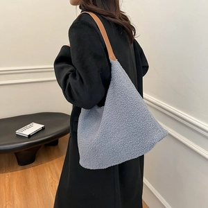 Light blue faux shearling tote bag with brown leather strap for autumn winter fashion