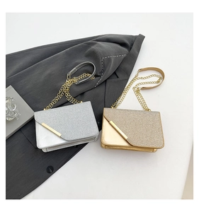 Close-up of glitter sequins and metallic leather flap bags with chain strap and metal trim