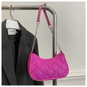 Detailed texture of hot pink quilted nylon crescent bag with elegant silver chain strap