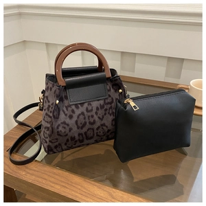 Detail of leopard print suede tote set with wooden handle and matching black pouch