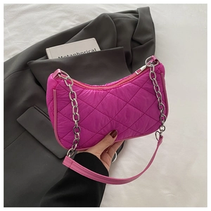 Detail of rose pink quilted underarm bag with silver chain and silk-textured nylon fabric