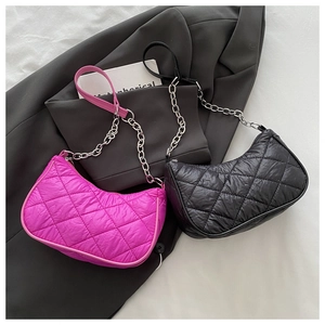 Detailed macro of diamond quilted textures on pink and black nylon chain shoulder bags