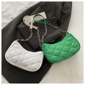 Close-up of quilted nylon crossbody bags with silver chain straps and diamond stitching