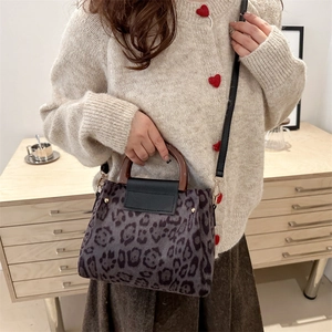 Large leopard print tote bag with vintage wooden handles and black leather flap