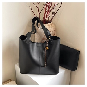 Minimalist black matte leather tote bag with inner pouch and decorative bead charm