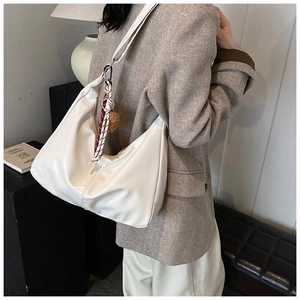 White faux leather hobo tote bag featuring a decorative black and white plaid scarf charm