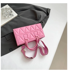 Detail showing pink triangular quilted PU leather texture and golden metal buckle