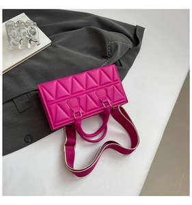 Detail of magenta triangle quilted tote bag with wide strap and gold hardware