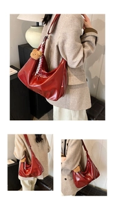 Chic red high-gloss tote bag featuring a cute plush bear charm and checkered ribbon detail