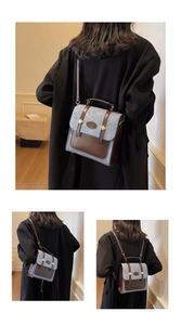 Detail of vintage patchwork backpack showing gray textured fabric and brown leather straps