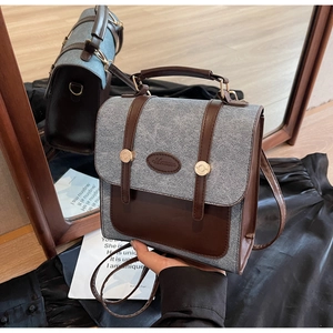 Detail of the vintage contrast fabric and leather tote bag with elegant gold buckle