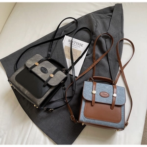 Detail of vintage canvas and faux leather backpack with decorative metal buckles