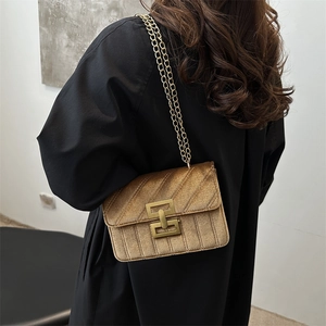Fashionable velvet quilted crossbody chain bag in bronze gold shown on model