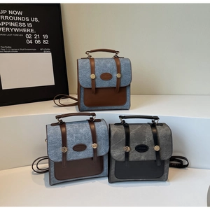 Close-up of vintage patchwork backpacks in wool and leather with metal buckle details