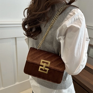 Quilted dark brown velvet crossbody bag with golden H-buckle and metal chain strap