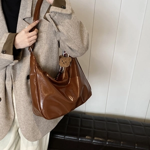 Minimalist large brown glossy tote bag with cute bear pendant for daily commuting
