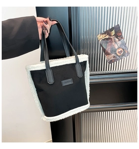 Detail of contrast stitch handbag with faux shearling trim and Fashion leather label
