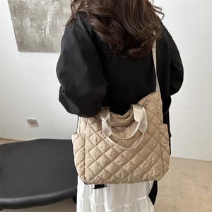 Quilted tote bag in beige with classic diamond stitching and adjustable shoulder strap