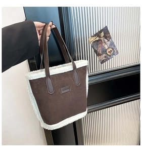 Detail of dark brown faux suede tote bag featuring white faux shearling trim and fashion label