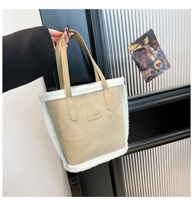 Detail showing plush faux fur trim and fashion leather patch on the beige suede tote bag