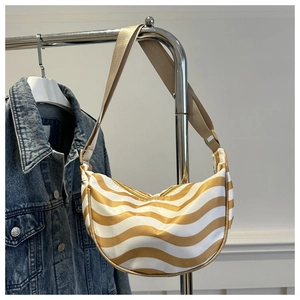 Detail of yellow and white wavy striped crescent bag hanging on a metal hanger