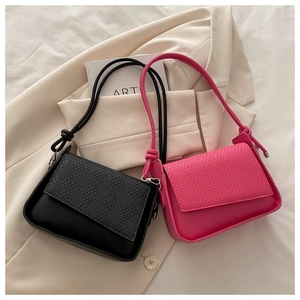 Detail of woven texture flap and knotted strap on black and pink small square bags