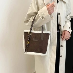 Brown suede bucket bag with white fleece trim and fashion label for winter commute