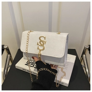 Close-up of a white suede rectangular bag with golden SS logo and fringe detail