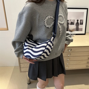 Fashionable contrast stripe crescent crossbody bag with wide shoulder strap in blue and white
