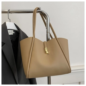 Detail der hellbeige Tote Bag mit goldenem geometrischem Verschluss und glattem Leder
