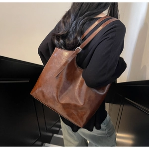 Detail view of retro brown oil wax leather tote bag showing texture and adjustable strap