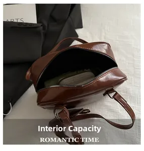 Macro view of retro brown shoulder bag interior showing storage space and zipper