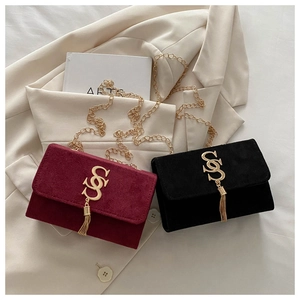 Detail of red and black suede small square bags with gold S-hardware and chain straps