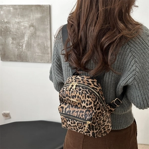 Chic leopard print mini backpack for women with gold hardware and stylish back-view fit