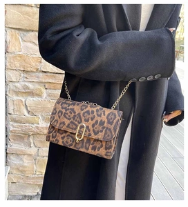Détail du sac bandoulière léopard avec chaîne dorée et fermoir rotatif ovale chic