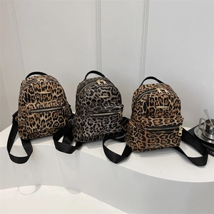 Three trendy leopard print mini backpacks in brown and grey with golden metal zippers