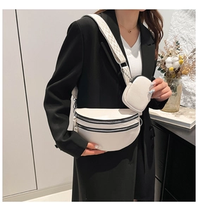 White pebbled leather moon bag with dual zippers and small round coin purse on wide strap