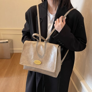 Retro beige oil-wax leather backpack with large capacity and elegant gold metal plate