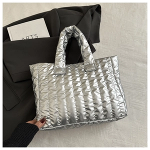 Silver metallic quilted tote bag with vertical stripes shown on a modern white background