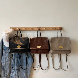 Retro wax leather backpack in black and coffee brown with gold logo and top handle