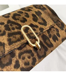 Détail de la boucle en métal doré et de l'imprimé léopard sur le petit sac bandoulière