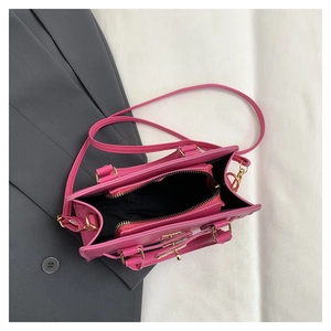 Top view of fuchsia leather handbag showing spacious interior and gold zip compartment