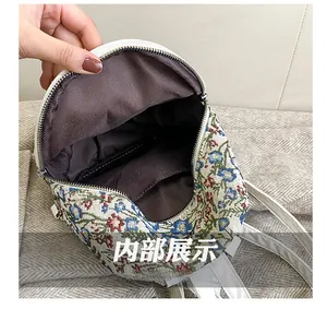 Top view of floral backpack showing spacious brown fabric interior and white zipper closure