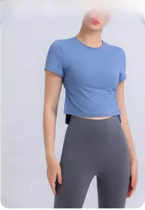 Detail view of adjustable side drawstring and ruched texture on blue yoga crop top