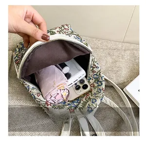 Internal view of floral backpack showing storage capacity for umbrella and phone