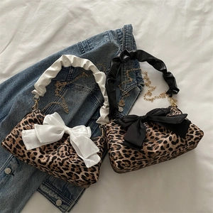 Leopard print baguette shoulder bag with oversized bow and ruched handle detail