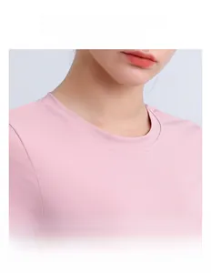 Detail of pink sports top featuring a classic crew neck and breathable elastic fabric